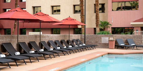 A pool with lounge chairs and umbrellas
