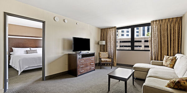 A hotel suite with a living area and bedroom